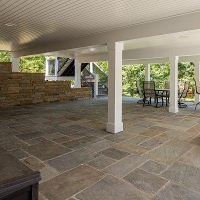 covered patio, white columns, and new retaining wall