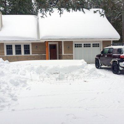 Snowy northern Michigan lake cottage driveway side